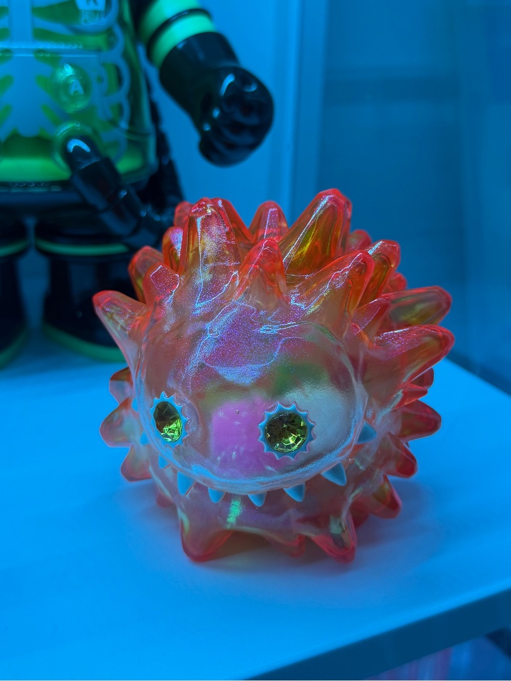 Big Liquid Erosion Monster Iridescent Spiky Orange with Pom Poms inside.